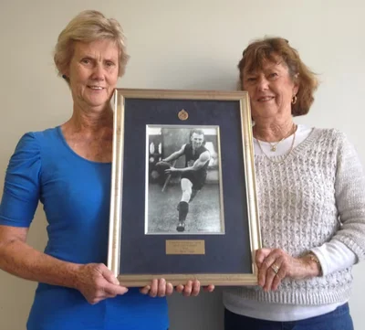 Mickey Crisp's daughters with his 1934 Best and Fairest Medal